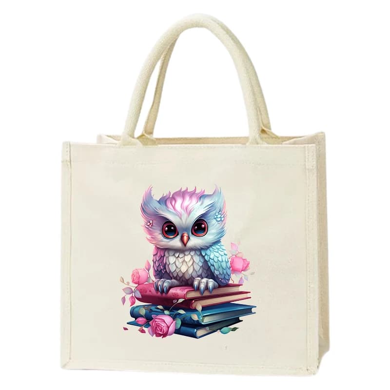 Purple owl lady canvas handbag with owl cotton gift bag and canvas shopping bag standing on top of the book